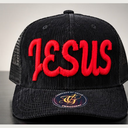 Black corduroy trucker snapback with red Jesus Script 3D puff embroidery on a clean studio background
