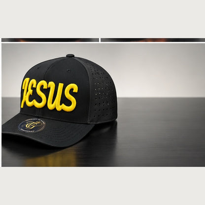 Angled black perforated snapback with yellow Jesus Script 3D puff embroidery on a clean studio background